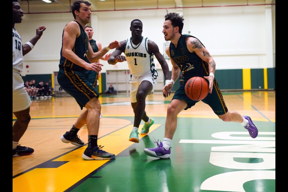 T-wolves guard Darren Hunter drives in with the ball during Saturday's game against the Saskatchewan Huskies at the NSC.