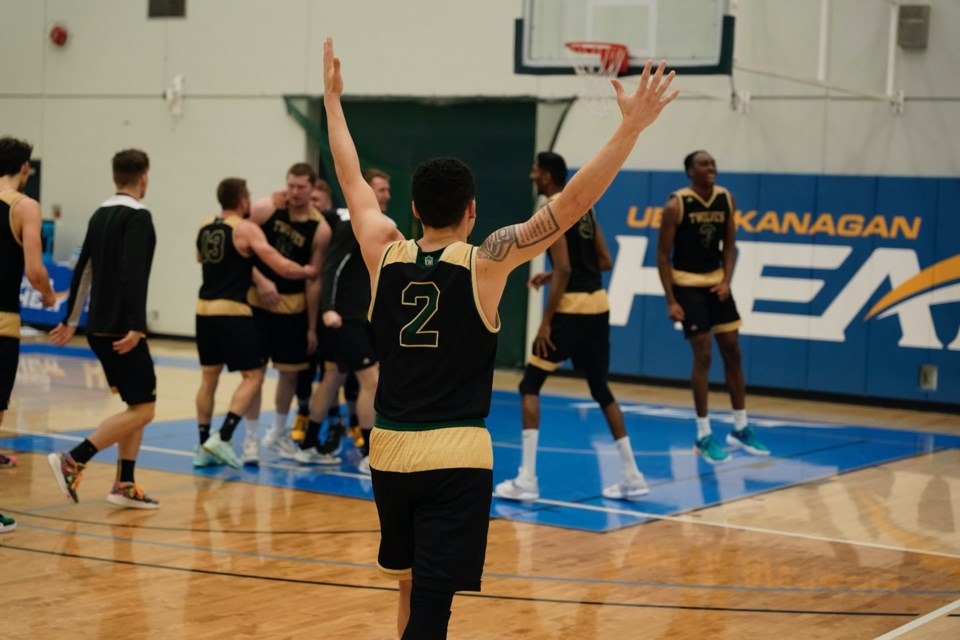 UNBC point guard Tyrell Laing (2) raises his hands in victory after the UNBC Timberwolves pulled off a last-second win over the UBC-Okanagan Heat Friday in Kelowna.                 