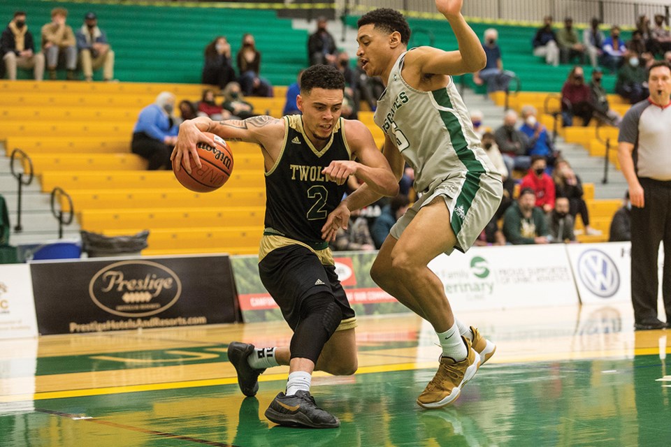 Citizen Photo by James Doyle. UNBC Timberwolves guard Tyrell Laing moves to keep the ball away from Fraser Valley Cascades defender Ahmad Athman on Saturday night at Northern Sport Centre.