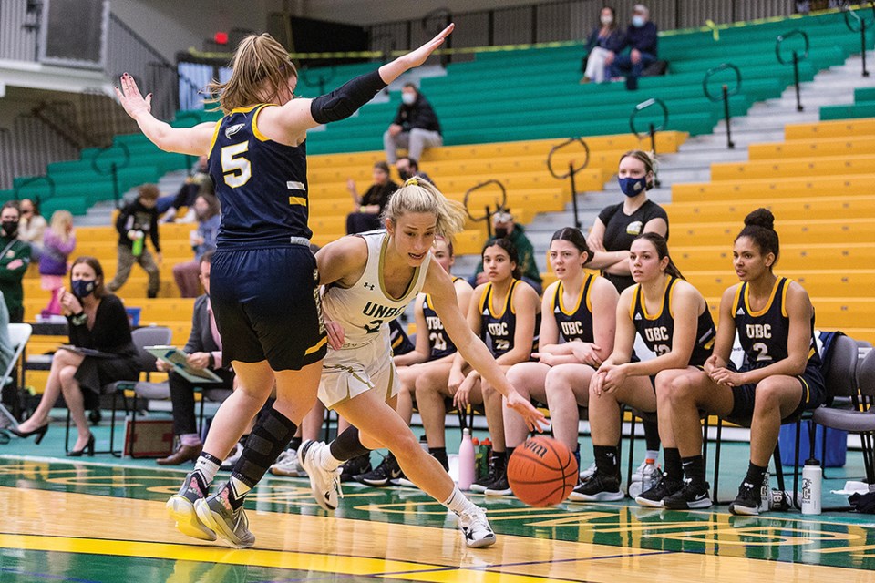 Citizen Photo by James Doyle. UNBC Timberwolves guard Anastasia Soltes drives to the net past UBC Thunderbirds defender Hailey Counsell on Thursday evening at Northern Sport Centre.