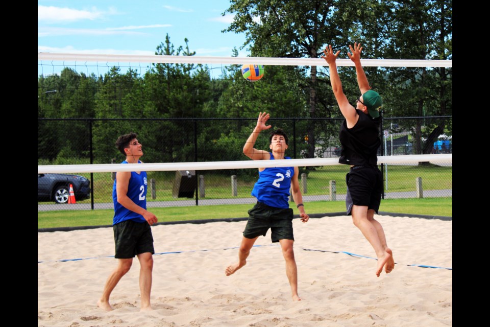 Esme Long of Cariboo-Northeast, centre, tips the ball against Kootenays opponent Ayden Wells, while his Cariboo teammate Isaak Lank looks on during a BC Summer Games practice match Thursday morning at Carrie Jane Gray Park.