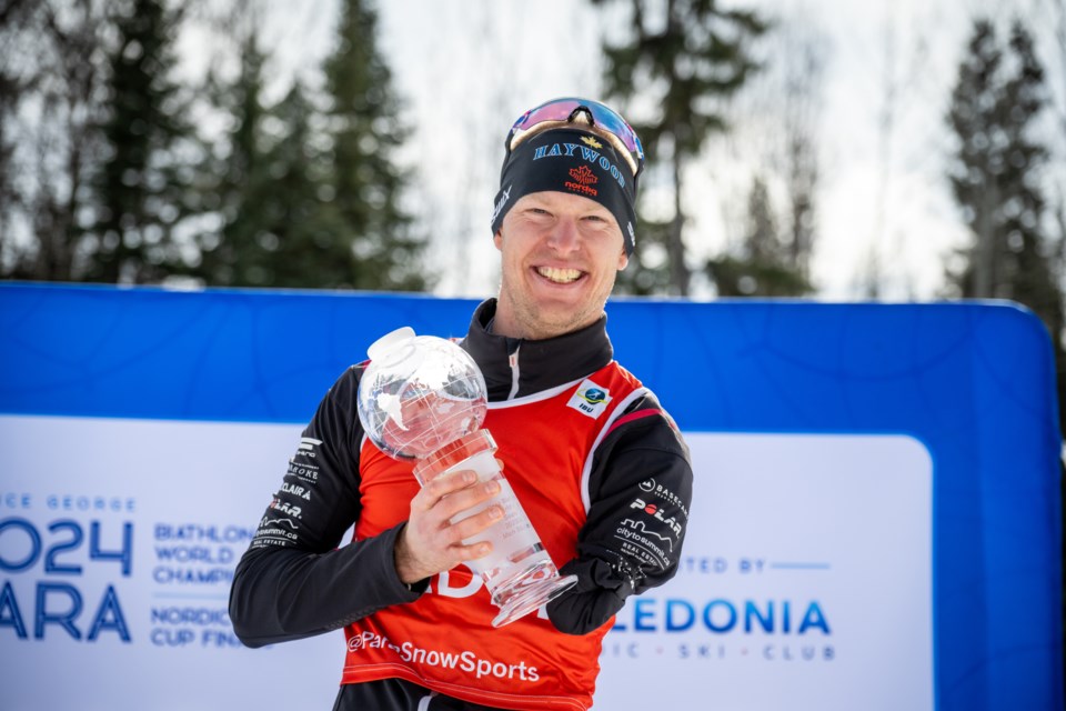 Mark Arendz holds the Crystal Globe he won Wednesday as FIS World Cup biathlon champion.