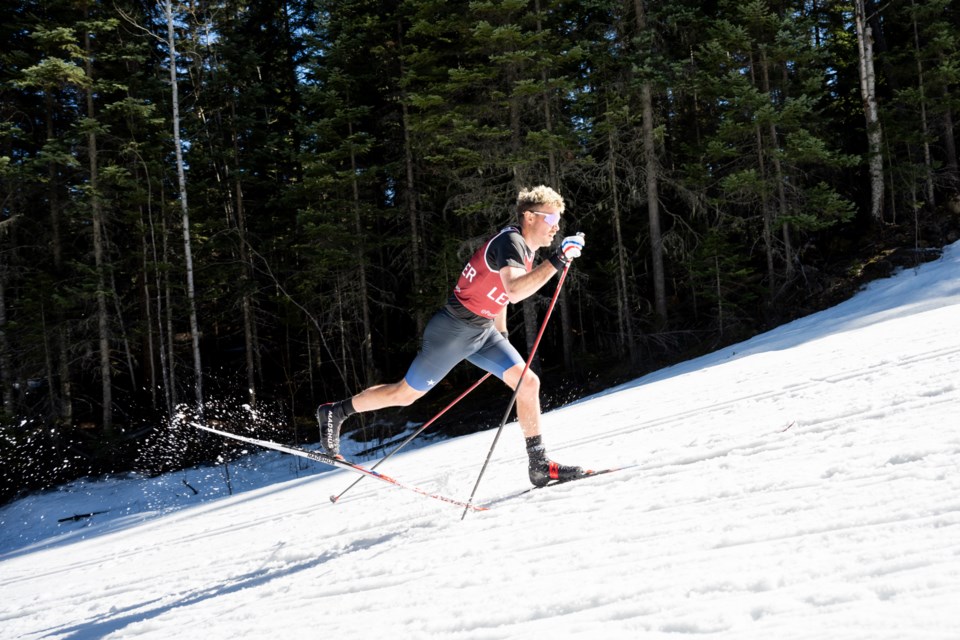 With the thermometer heading to 20 C, Jake Adicoff kicks up some wet snow as he motors up a hill during Sunday's Para Nordic World Cup Finals 20 km standing class race at Otway Nordic Centre