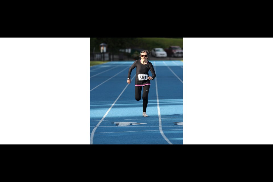 Christa Bortignon sprints to a world record finish during the 200m race held Friday evening at the Spruce Capital Meet hosted by the Prince George Track & Field Club at Masich Place.