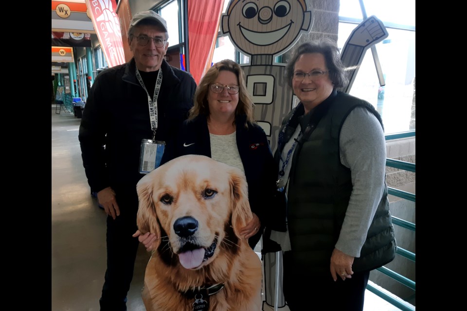 Wayne and Arlene Anderson, flank Linda Christensen, holding a cardboard cutout of her family dog Lester, after they watched their daughters lose 8-6 to Sweden in a playoff game Saturday at the BTK Tires & OK Tire World Women's Curling Championship at CN Centre. 