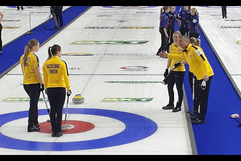 Team Sweden coach Wayne Middaugh makes a few suggestions during a timeout in their Game Thursday night against Team USA. The three-time world champion Middaugh is in his fourth season coaching the team. 