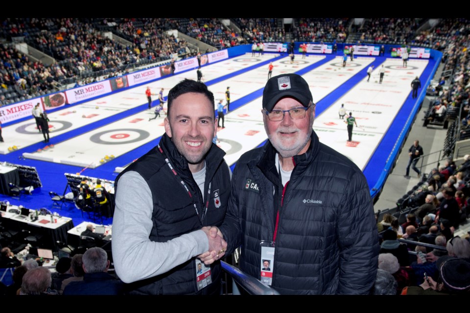 David Murdoch, left, and Gerry Peckham pose for a photo at the 2023 Brier Canadian men's curling championship March 9 in London, Ont. Murdoch has been hired to replace Peckham as Curling Canada' high- performance director for next season.