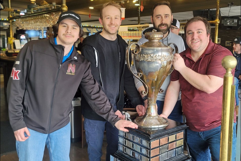 The 2025 Kelly Cup men's curling bonspiel champions from Quesnel, from left, second Colorado Marr, lead Daryc Langlois, third David Henderson and skip Justin Nillson, pose with the big trophy they won Sunday, April 6, 2025 at Prince George Golf and Curling Club.