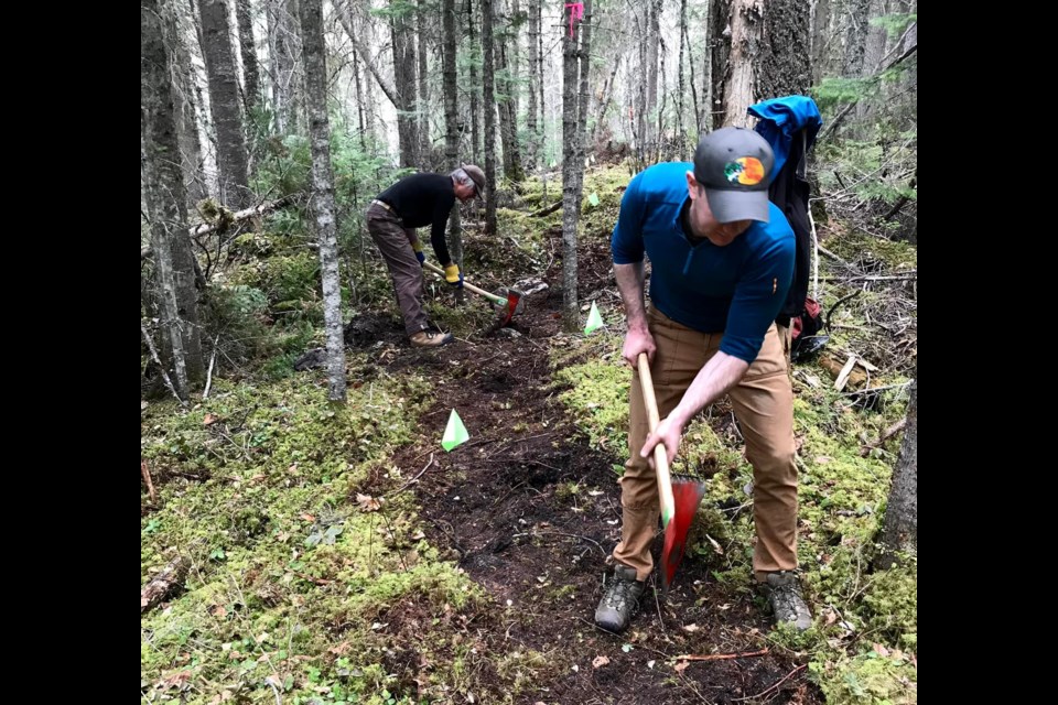 Volunteers working on new single-track trails on Tabor Mountain off Groveburn Road.