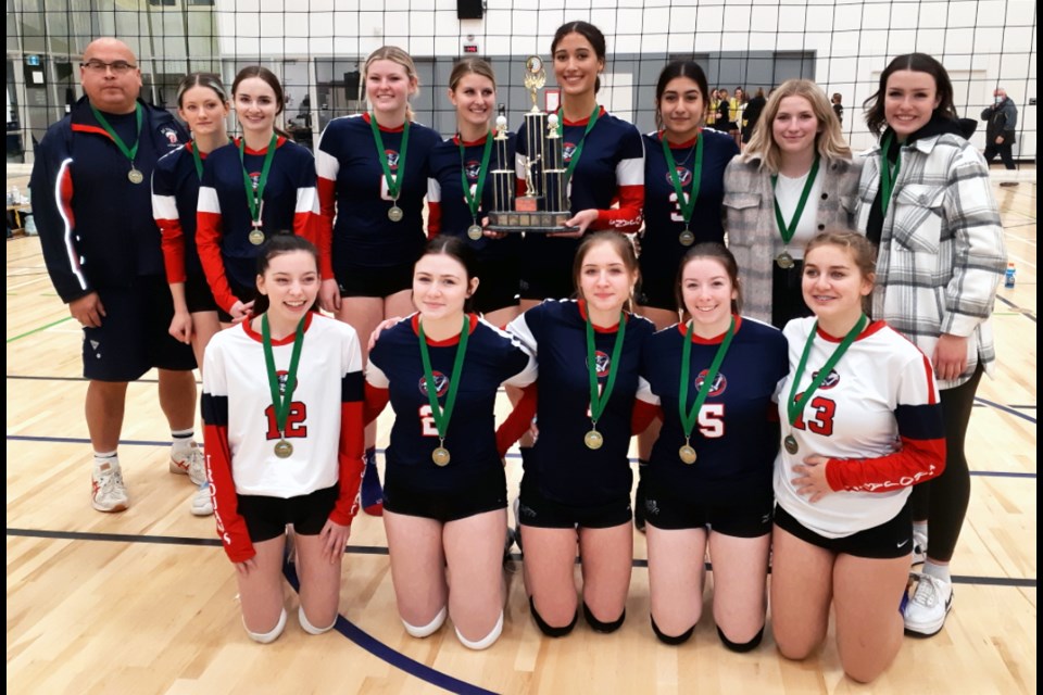 The D. P. Todd Trojans celebrate their win in the North Central zone double-A girls volleyball championship match Saturday at Shas Ti Kelly Road gym. They beat the host Grizzlies three sets to one in the final. 