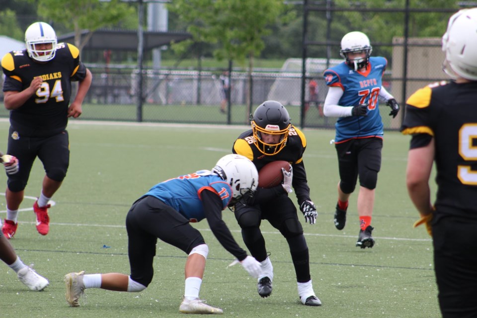 Prince George U-16 Kodiaks ball carrier Peyton Briere tries to avoid a tackle during Saturday's BCPFA Academy Tournament in Surrey.