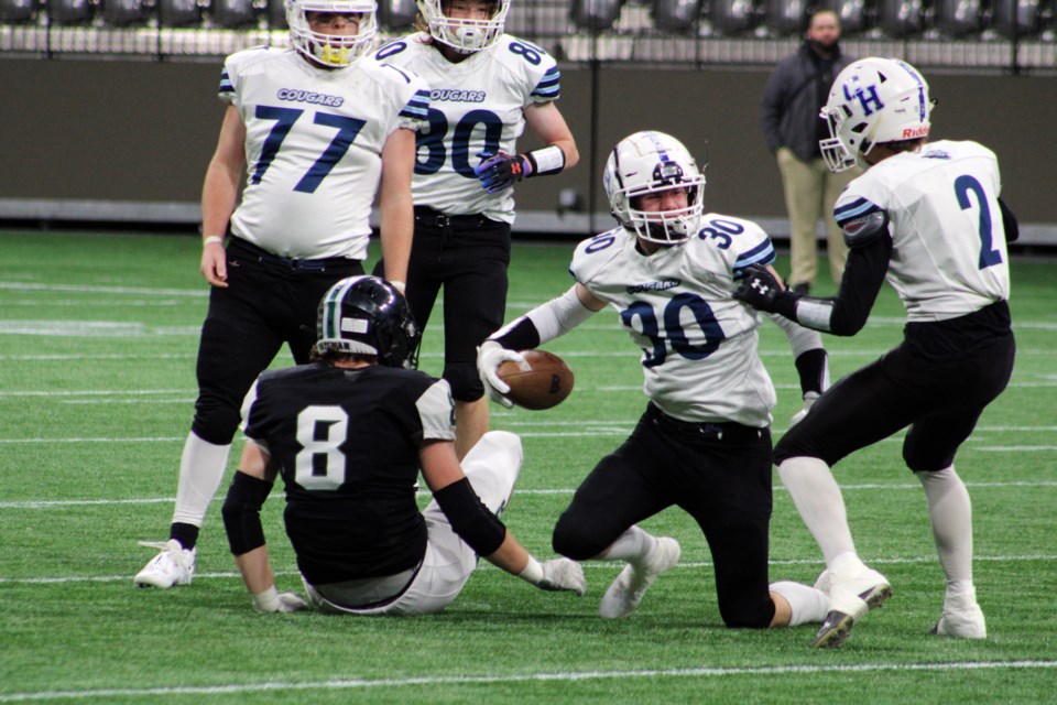 College Heights Cougars linebacker Aiden Smith comes up with the ball during the BCSSFA double-A varsity semifinal against the Robert Bateman Timberwolves Saturday at B.C. Place Stadium in Vancouver,