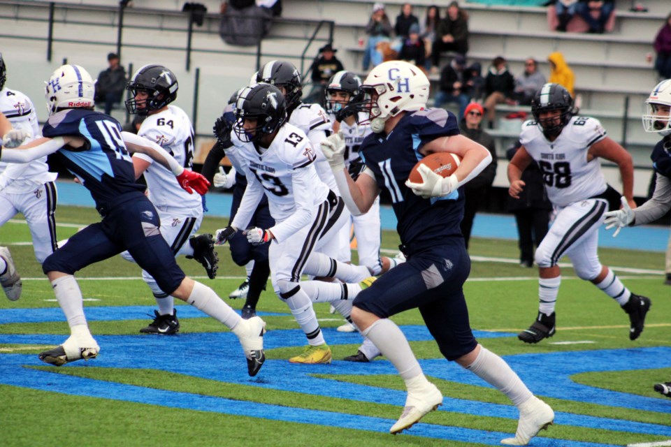 College Heights Cougars running back Aiden Smith takes off on a run during first-half high school football wild-card playoff action against the South Kamloops Titans Saturday at Masich Place Stadium. The Titans went home with a 21-13 victory.