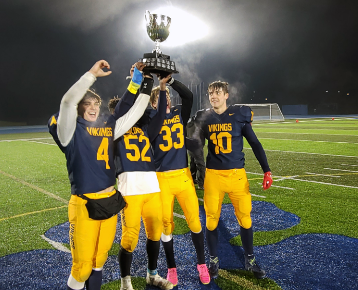 Nechako Valley Vikings captains, from left, Cooper Ziler, Ben Wall, Grayson Turgeon and Cole Malo hoist the Matt Pearce Memorial Trophy after they blanked the College Heights Cougars 26-0 in Friday's P.G. Bowl high school football championship at Masich Place Stadium.