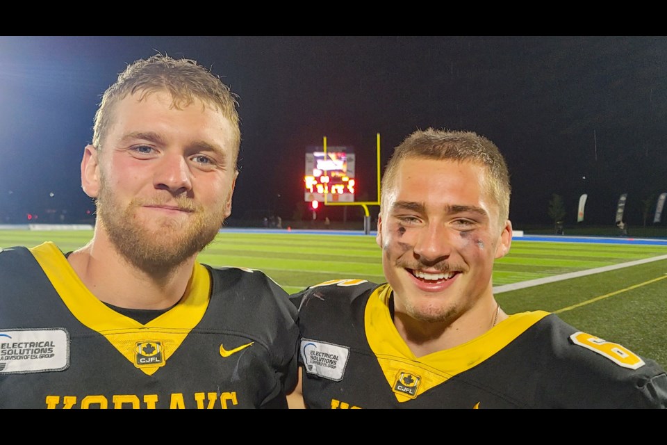 Kodiaks quarterback Sawyer Thiessen, left, and defensive back Dillon Piddocke savour their 33-13 win over the Langley Rams in BCFC junior football action at Masich Place Stadium on Saturday, Aug. 16, 2025.