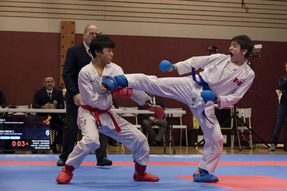 Cillian Hollybow of Prince George lands a kick on Fyodor Joe of Kelowna during the BC Winter Games kumite U-14 plus-163 cm advanced final in Quesnel.
