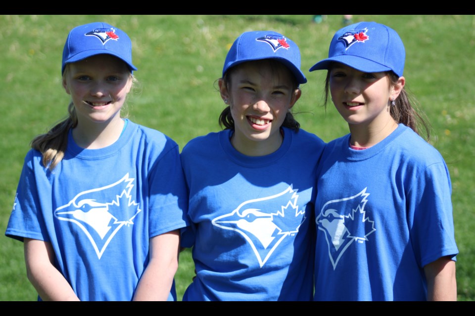 Madison Doyle, Summer Haugan and Addyson Doig, all 11 year old Beaverly Elementary students, were participants in the Girls at Bat program that saw about 26 elementary school students gather on the field at Spruceland Traditional Elementary School Tuesday morning for a tournament to show off some baseball skills they have recently learned.