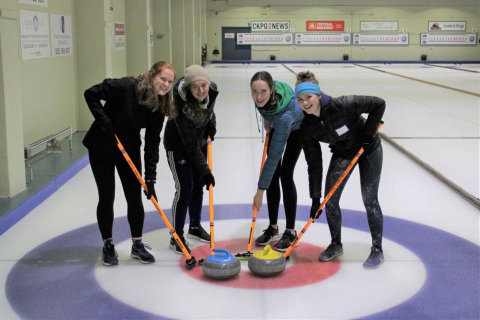 Kiersten Mikkelsen, left, Abigail Yoder, Jasmin Schlick and Alexis Seely, all second year UNBC students, came together during the Girls Rock event presented by Curling Canada for those with little to no experience in curling to have a little fun and see what curling was all about.
