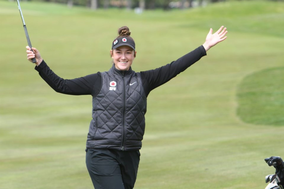 Natasha Kozlowski of Prince George celebrates after she chipped in for a birdie on No. 18 in her second and final round at the GNAC women's golf championship Tuesday in Coeur d'Alene, Idaho. 