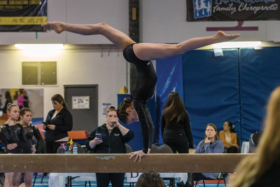 Citizen Photo by James Doyle. A gymnast performs a routine on the balance beam on Sunday afternoon at the Prince George Gymnastics Club while competing in the 2022 Prince George Gymnastics Invitational.