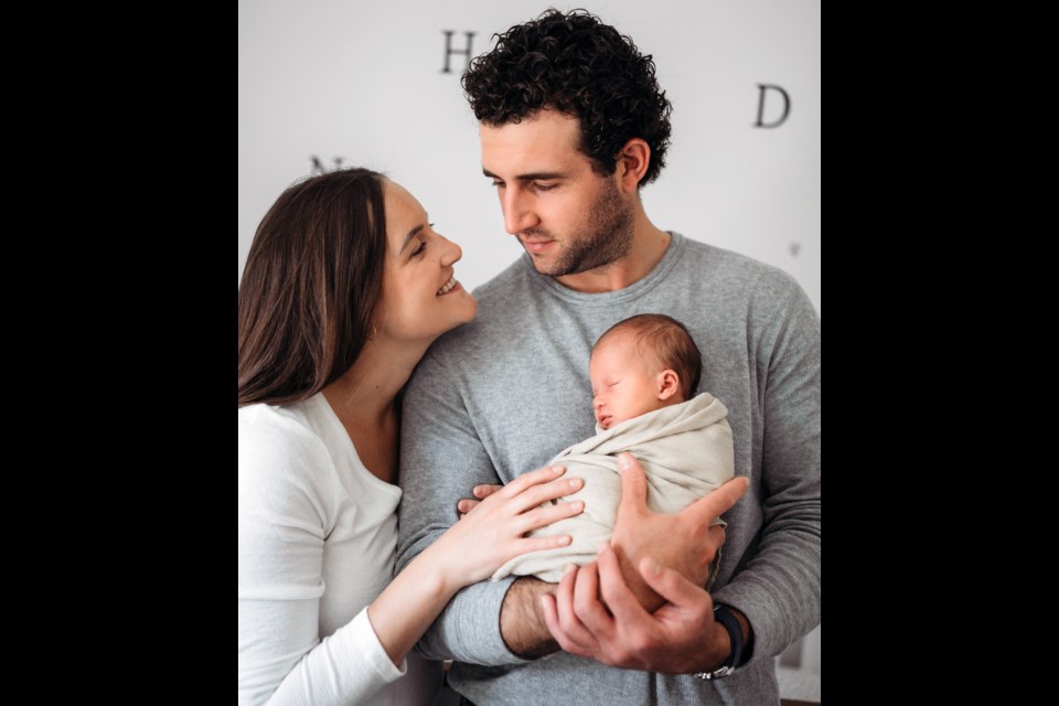 Pro hockey defenceman Brandon Manning holds his baby daughter Nora, flanked by his wife Shea-Mare. The Mannings are traveling this weekend to Gerrmany, where Manning will suit up this season for the Straubing Tigers.