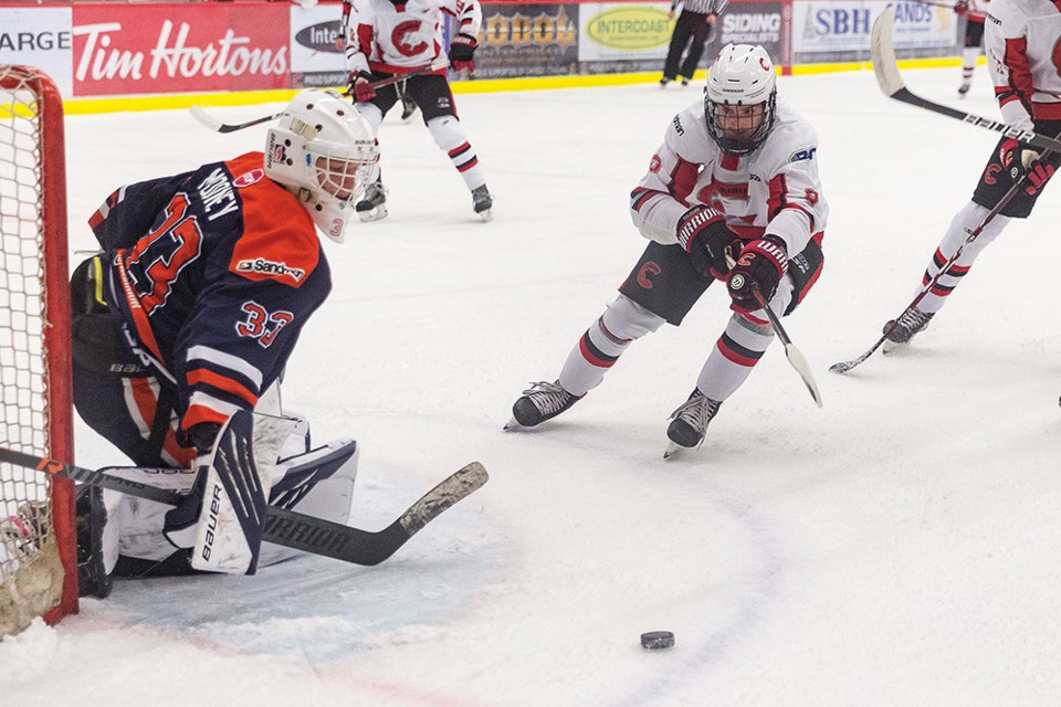 Citizen Photo by James Doyle. Cariboo Cougars forward Chase Pacheco chases the loose puck in front of Thompson Blazers goaltender Kellan Mooney on Saturday afternoon in Kin 1 during BCEHL U18AAA hockey action.