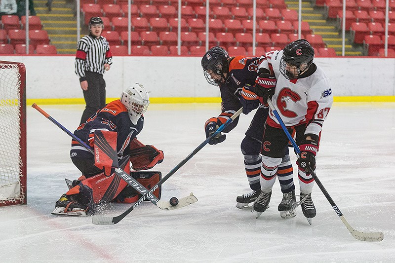 Citizen Photo by James Doyle. Cariboo U17AAA Cougars forward Blake Pigeon battles Thompson Blazers defender Jobie Siemens for the loose puck in front of goaltender Preston Lewis on Sunday in Kin 1 during BCEHL U17AAA action.