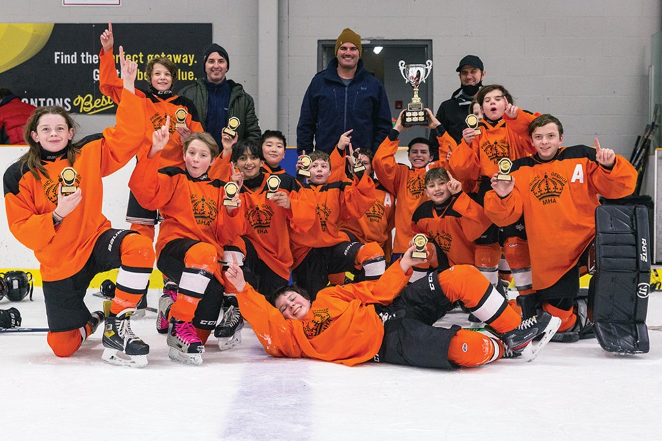 Citizen Photo by James Doyle. The Citizen Orange Tigers pose for a team photo with their hardware after winning the Ethan Blacker Memorial U13 Tier 1 hockey tournament on Sunday afternoon in Kin 2.