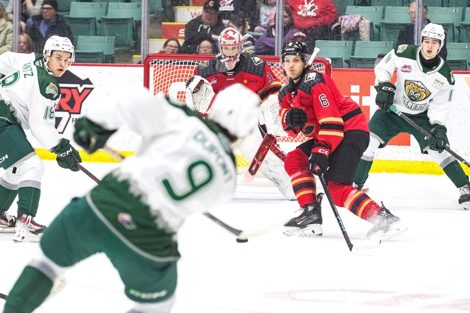 Everett Silvertips defenceman Landon DuPont lets a point shot go at Prince George Cougars goalie Josh Ravensbergen while Cats defenceman Viliam Kmec stands guard Friday, Feb. 14, 2025 at CN Centre in Prince George, BC.