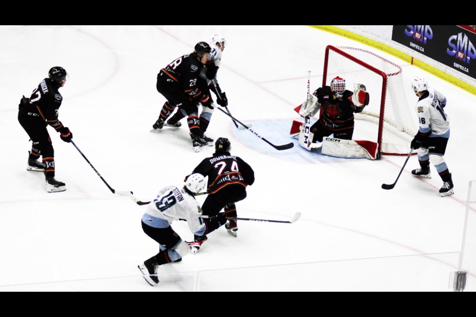 Cougars goalie Ty Young puts up his trapper to deny a hot shot from Portland Winterhawks right winger James Stefan during the second period Saturday at CN Centre.