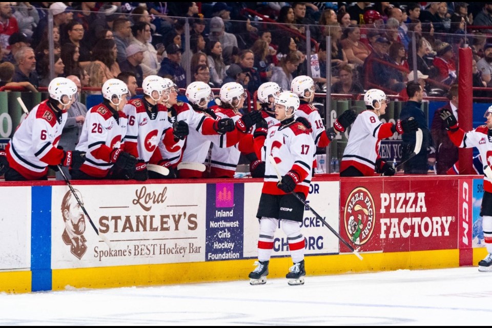 Zac Funk leads the Prince George Cougars' celebration parade after one of his two goals Tuesday in Spokane. The Cats won 4-2 to take a 3-0 series lead.