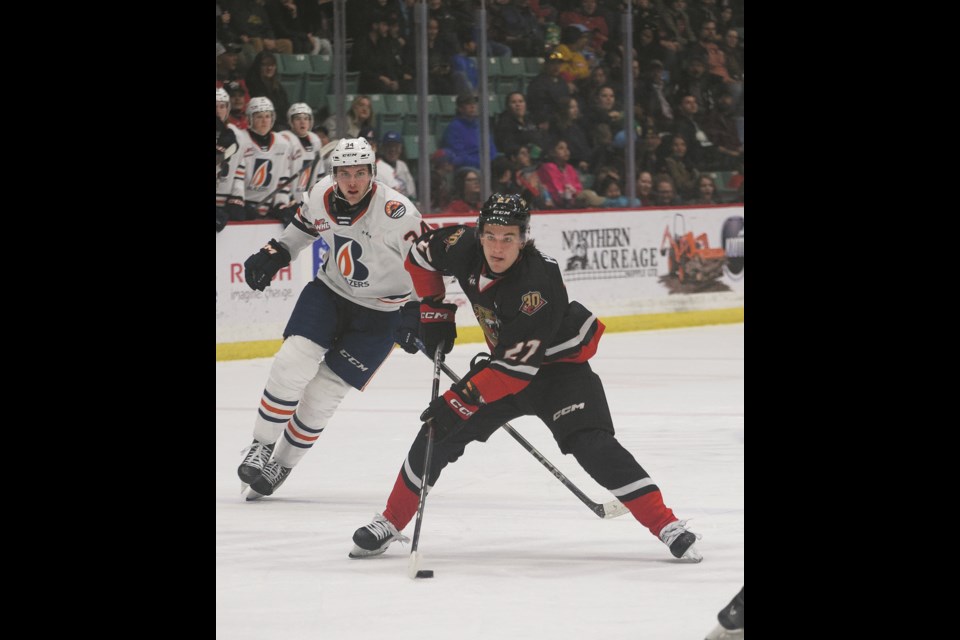 Prince George Cougars centre Riley Heidt steadies the puck after beating Kamloops Blazer Ashton Ferster during second-period action on the way to a hat trick in the Cougars' final regular season game at home at CN Centre Saturday night.
