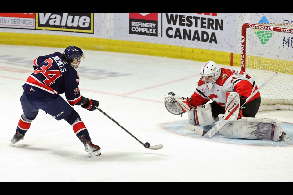 Cougars goalie Josh Ravenbergen sticks out his glove to make one of his 23 saves in a 4-0 win over the Regina Pats Sunday in Regina. It was the second shutout of the season for the 16-year-old rookie from North Vancouver.