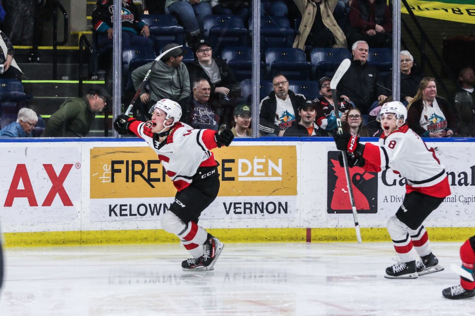 Cougars centre Matteo Danis, left, and linemate Oren Shtrom celebrate their overtime victory over the Kelowna Rockets Tuesday in Kelowna.
