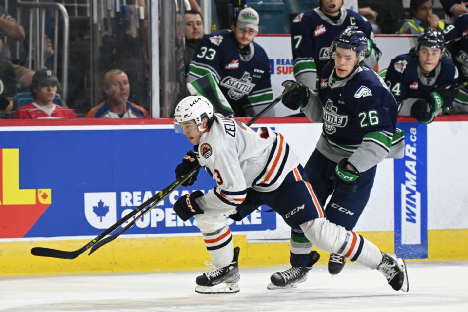 Seattle Thunderbirds winger Nico Myatovic, left, and Kamloops Blazers defenceman Olen Zellweger chase down a loose puck during their game Wednesday at the Memorial Cup in Kamloops.