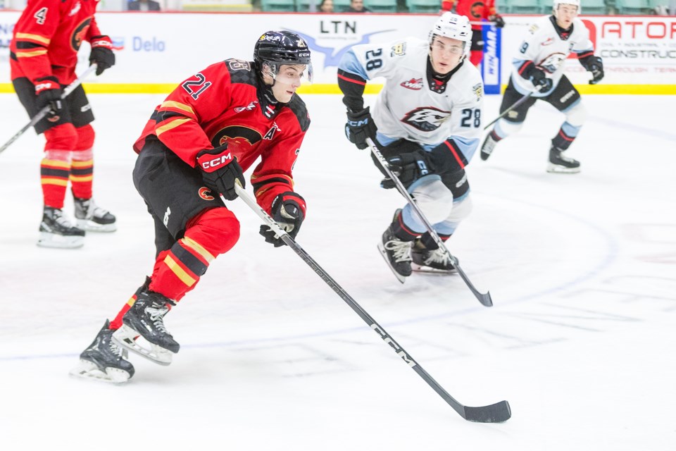 Cougars winger Ondrej Becher moves the puck away from Portland Winterhawks checker Josh Zakreski during game action in February at CN Centre.