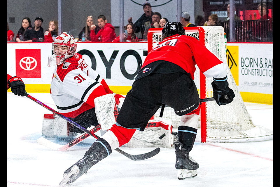 Prince George Cougars goalie Josh Ravensbergen does the splits to get his pad in front of a labeled shot from Portland Winterhawks forward Josh Zakreski during their playoff game on Wednesday, April 2, 2025 in Portland, Ore. Ravensbergen is the top-ranked North American goalie on NHL Central Scouting's final draft list.