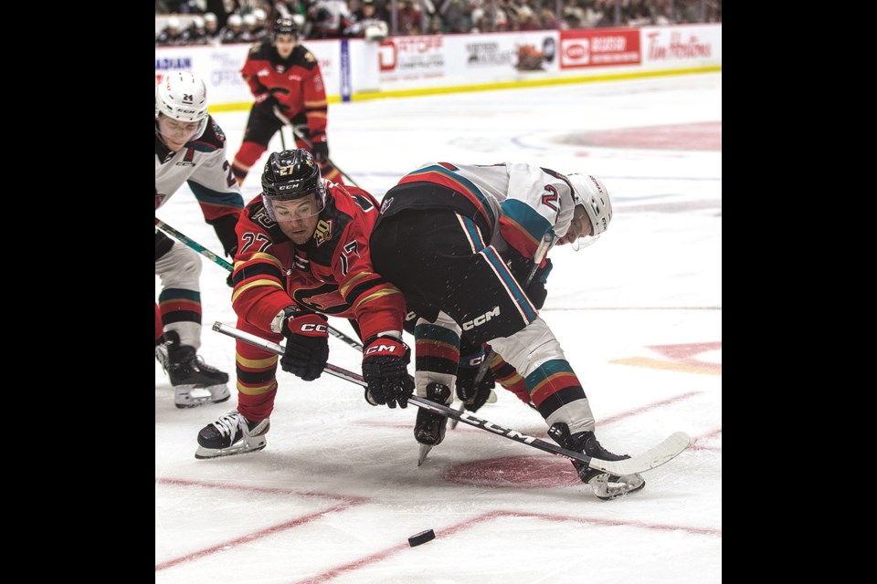 Prince George Cougars centre Riley Heidt pushes his way around Kelowna Rockets forward Gabriel Szturc during second-period action in Game 1 of their second round playoff series last April at CN Centre. Heidt has been selected for Canada's world junior team selection camp which starts Dec. 10 in Ottawa.
