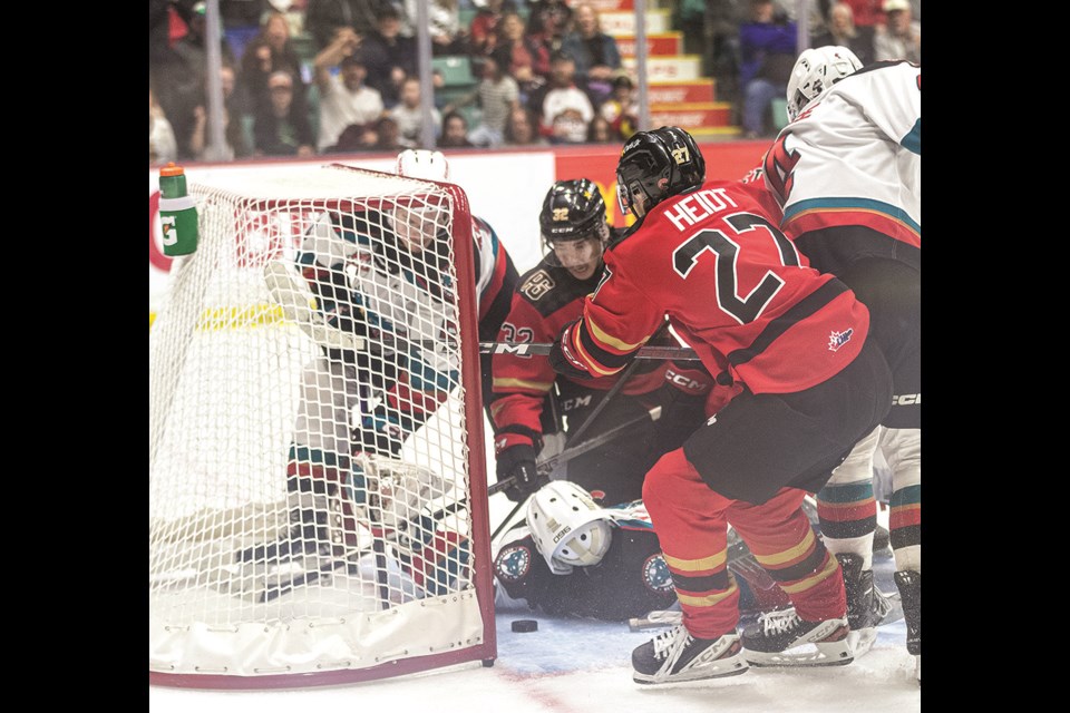 Prince George Cougars forward Riley Heidt (27) and teammate Terik Parascak (32) watch as Heidt's shot slides through the crease as he scores his first goal of the night during second period action at CN Centre Friday night.

