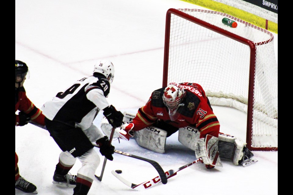 Joshua Ravensbergen makes one of his 30 saves against Vancouver Giants captain Samuel Honzik during the second period Friday. The Cougars went onto win 5-3.