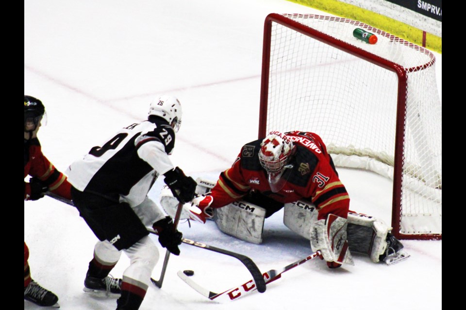 Joshua Ravensbergen makes  the save against Vancouver Giants captain Samuel Honzik during a game March 8, 2024 at CN Centre.