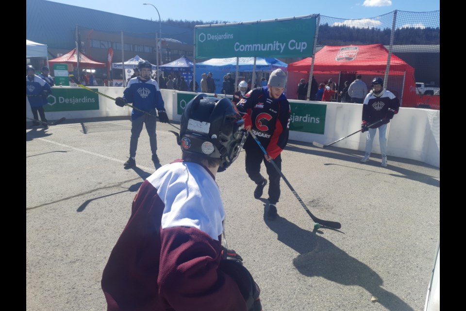 Craig Armstrong, in his No. 22 Prince George Cougar jersey, leads the Lightning attack against the Maroons during their Desjardins Community Cup Shootout ball hockey game at the Rogers Hometown Hockey festival Sunday at CN Centre parking lot.