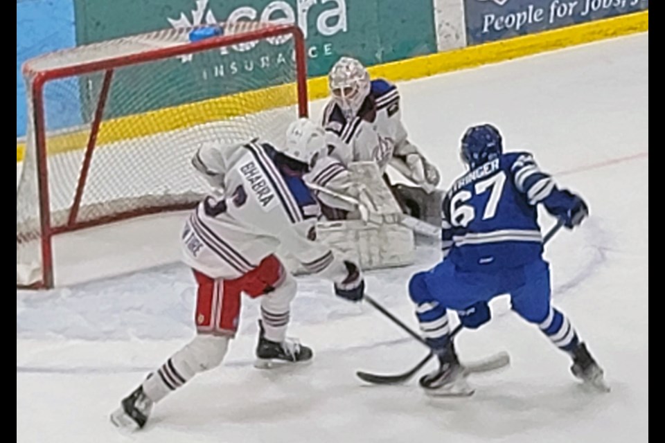 Spruce Kings goalie Ryan Sanborn gets down to his knees to make the save off Penticton Vees left winger Zack Stringer  while defenceman Amran Bhabra moves in for the check during second-period action Tuesday at Kopar Memorial Arena.