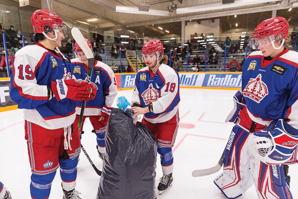 Citizen Photo by James Doyle. Prince George Spruce Kings players put gloves, socks, and toques into a garbage bag on Friday night at Rolling Mix Concrete Arena on Drop The Gloves and Sock It to Em night with all items collected being donated to the St. Vincent de Paul Society.