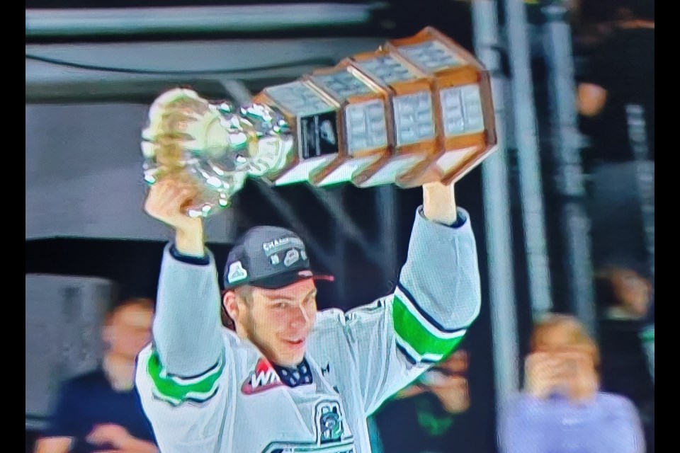 Nico Myatovic of Prince George hoists the Ed Chynoweth Cup over after he helped the Seattle Thunderbirds  defeat the Winnipeg ICE 3-1 to win the WHL championship series 4-1 Friday in Kent, Wash.