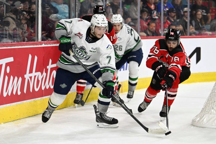 Seattle Thunderbirds centre Jordan Gustafson (7) fights off Quebec Remparts defenceman Jeremy Langlois (78) while T-birds Nico Myatovic (26) pinches Quebec's Nicolas Savoie (14) into the boards behind the Remparts' net during Monday's game at the Memorial Cup in Kamloops. 