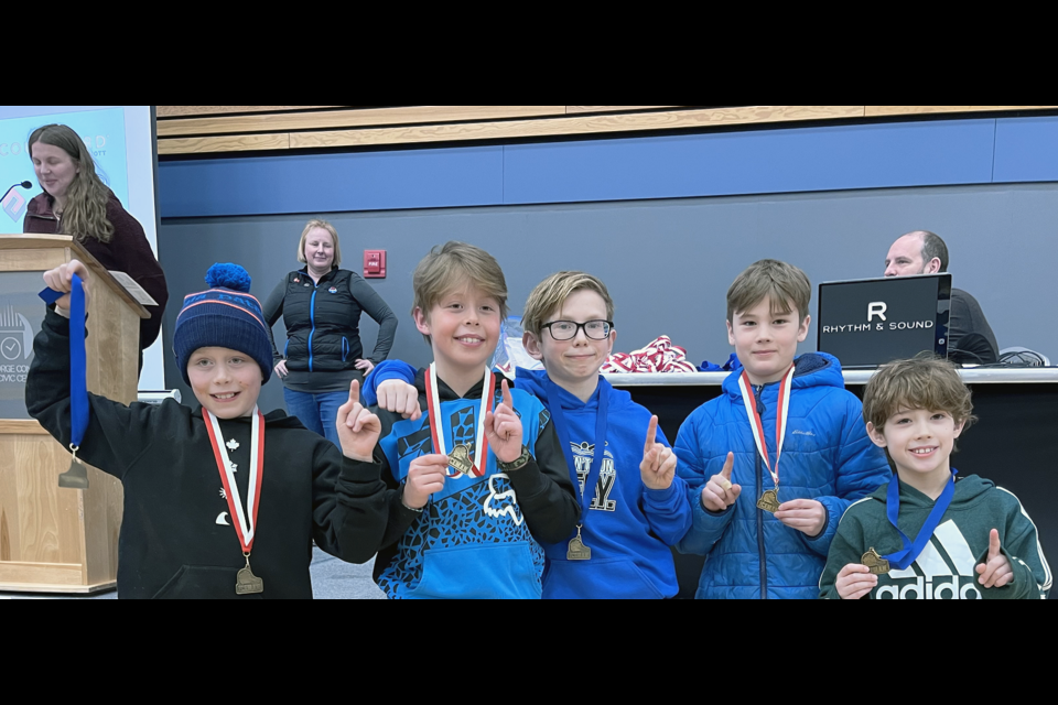The Ice Boys hold up their medals after winning the junior boys team category at Sunday's Prince George Iceman.