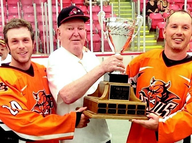 Fred Doig hands the Fred Doig Trophy to provincial senior C champions Dave Bennett, left, and Blake McIntosh of the Westwood Pub Devils in July 2014. The Devils are among seven teams vying for the BC senior C provincial and invitational titles, Aug. 8-10 at the Kin Centre. 