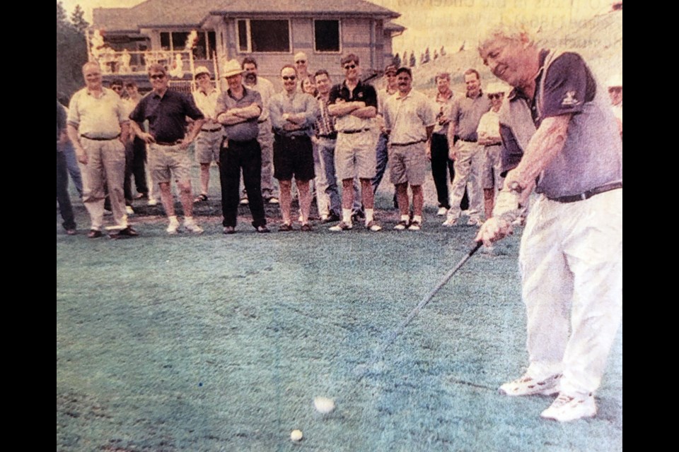 On May 15, 1999, Aberdeen Glen Golf Course owner Mike Church puts all his might into his drive on No. 1 to officially open the Prince George golf course in front of a gallery of onlookers.