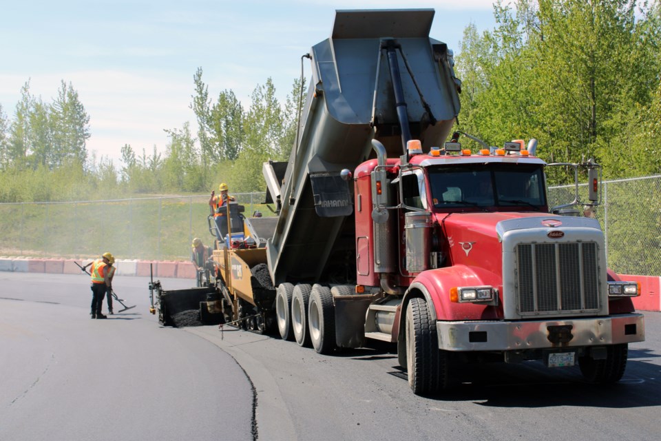A paving crew from Lafarge Canada puts down a layer of new asphalt at PGARA Speedway on Wednesday. The city's home of stock car racing, a three-eighths-mile oval track operated by the Prince George Auto Racing Association, is being repaved this week.